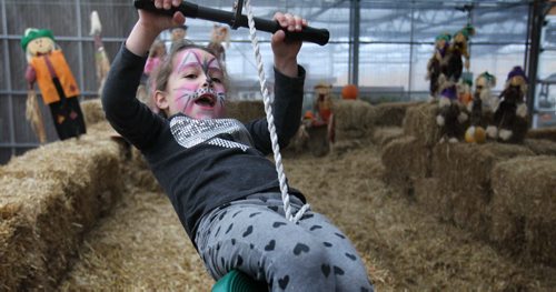 Six-year-old Maya Marrese rides a zip line in the Fun Zone with her cousin Kaili (pink)  at Shelmerdines which is open daily till Oct 31/15. Standup photo    Oct 27, 2015 Ruth Bonneville / Winnipeg Free Press