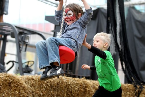 Brothers Connor Nichols -7yrs (green) and  Hayden Nichols 4yrs,  give each other a push while playing in the Halloween Fun Zone at Shelmerdines which is open daily till Oct 31/15   Oct 27, 2015 Ruth Bonneville / Winnipeg Free Press