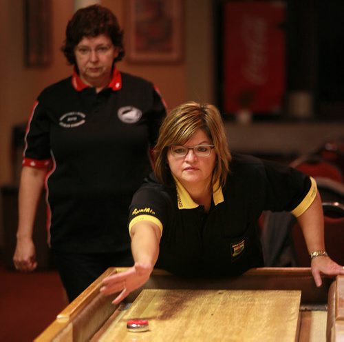 Wendy Popke watches as Cynthia Chudyk-Collins delivers at the John Osborne ANAF Legion Wednesday night. The shuffleboarders at the legion hosted the National Championships three weeks ago. See Dave Sanderson's story.  October 28, 2015 - (Phil Hossack / Winnipeg Free Press)