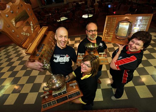 Left to right Mike Jacoby, Mike Collins, Wendy Popke and Cynthia Chudyk-Collins (front) hoist the hardware at the John Osborne ANAF Legion Wednesday night. The shuffleboarders at the legion hosted the National Championships three weeks ago. See Dave Sanderson's story.  October 28, 2015 - (Phil Hossack / Winnipeg Free Press)