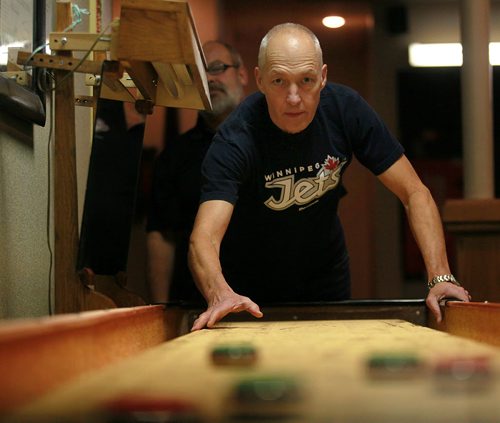 Mike Jacoby, takes aim at the hardware at the John Osborne ANAF Legion Wednesday night. The shuffleboarders at the legion hosted the National Championships three weeks ago. See Dave Sanderson's story.  October 28, 2015 - (Phil Hossack / Winnipeg Free Press)