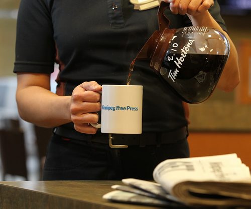 Promo set-up photo for website. Photo of Tim Horton's employee pouring coffee into a Free Press mug.  Photo taken at Inkster Ave. Tim's. Oct 28, 2015 Ruth Bonneville / Winnipeg Free Press