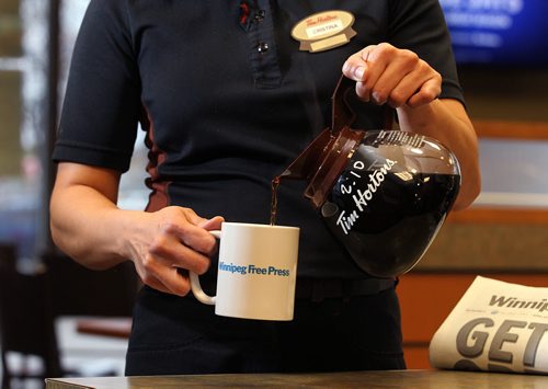 Promo set-up photo for website. Photo of Tim Horton's employee pouring coffee into a Free Press mug.  Photo taken at Inkster Ave. Tim's. Oct 28, 2015 Ruth Bonneville / Winnipeg Free Press