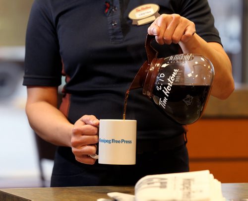 Promo set-up photo for website. Photo of Tim Horton's employee pouring coffee into a Free Press mug.  Photo taken at Inkster Ave. Tim's. Oct 28, 2015 Ruth Bonneville / Winnipeg Free Press