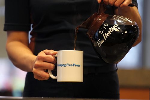 Promo set-up photo for website. Photo of Tim Horton's employee pouring coffee into a Free Press mug.  Photo taken at Inkster Ave. Tim's. Oct 28, 2015 Ruth Bonneville / Winnipeg Free Press