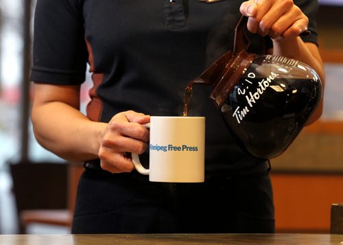 Promo set-up photo for website. Photo of Tim Horton's employee pouring coffee into a Free Press mug.  Photo taken at Inkster Ave. Tim's. Oct 28, 2015 Ruth Bonneville / Winnipeg Free Press