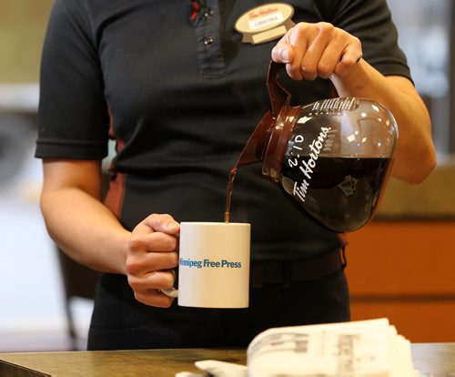 Promo set-up photo for website. Photo of Tim Horton's employee pouring coffee into a Free Press mug.  Photo taken at Inkster Ave. Tim's. Oct 28, 2015 Ruth Bonneville / Winnipeg Free Press