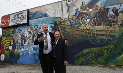 At left, Tom Ethans, Executive Director of Take Pride Winnipeg with Tam Nguyen by the mural depicting the journey of Tam's and other Vietnamese refugees that eventually ended in Winnipeg. In 1980, Nguyen came to Canada as a refugee from Vietnam with no money, no understanding of English and no education. Today, he owns three buildings and three businesses. The mural by Sarah J. Collard commissioned by Take Pride Winnipeg on the side of Joy's Convenience Store at 248 River Ave., a building Tam owns was officially unveiled Thursday morning. Wayne Glowacki / Winnipeg Free Press October 29 2015 ¤
