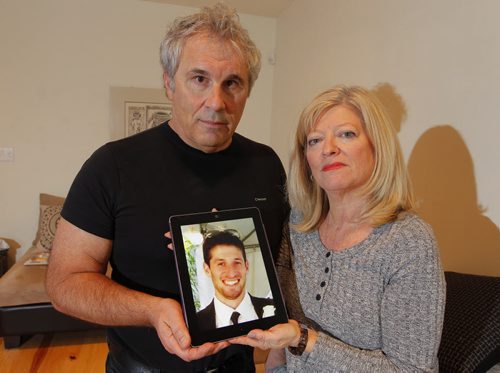 Photo of George and Bonnie Bricker, parents of missing 33-year-old son and sculptor Reid Bricker (in photo being held by them). BORIS MINKEVICH / WINNIPEG FREE PRESS  OCT 30, 2015