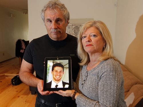 Photo of George and Bonnie Bricker, parents of missing 33-year-old son and sculptor Reid Bricker (in photo being held by them). BORIS MINKEVICH / WINNIPEG FREE PRESS  OCT 30, 2015