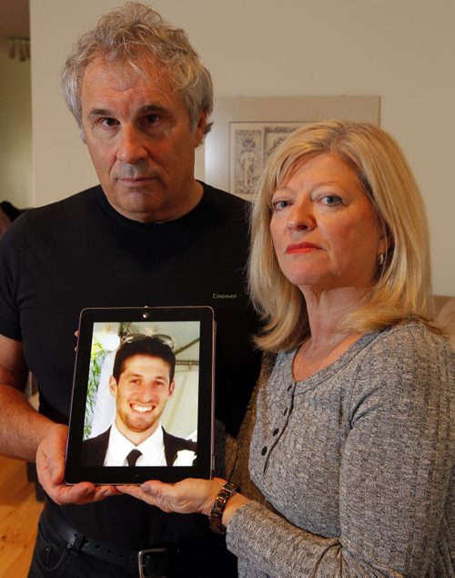 Photo of George and Bonnie Bricker, parents of missing 33-year-old son and sculptor Reid Bricker (in photo being held by them). BORIS MINKEVICH / WINNIPEG FREE PRESS  OCT 30, 2015