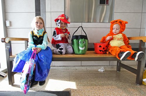 Kids dressed up in costumes eagerly dig into their bags of goodies after trick or treating around Kildonan Place Mall with friends and family members Friday at their annual Halloween event.    Names from left: Alexa Cadman-4yrs (Princess), Jackson Arundell -21/2yrs (Marshall) and Hunter Pollock -2yrs (Tigger).  Standup photo Oct 29, 2015 Ruth Bonneville / Winnipeg Free Press