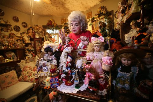 Rozalynde McKibbin is an antique doll collector.  Her home is a museum with over 1000 dolls that she has purchased, been given or she has created herself over her lifetime.   Here McKibbin looks at a display of dolls on a shelf some of which she made like the Princess Diana doll (below her to her right).  See Alex Paul story.  Oct 29, 2015 Ruth Bonneville / Winnipeg Free Press
