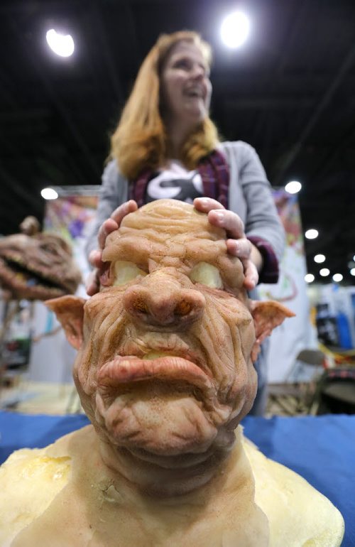 Lauren Cochrane of the Royal Awesome Society shows off a mask ('The Ork') made by her husband Aaron Merke at Central Canada Comic Con at RBC Convention Centre Winnipeg on Oct. 31, 2015. Photo by Jason Halstead/Winnipeg Free Press