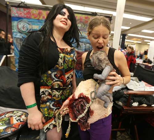 Body artist Samantha Ann Christianson (left), of Visual Eye Candy, helps Sara Baxter with her zombie costume at Central Canada Comic Con at RBC Convention Centre Winnipeg on Oct. 31, 2015. Photo by Jason Halstead/Winnipeg Free Press