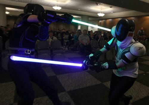 Winona Casavant (right) and Tim Webster of River City Jedi martial arts school take part in a light sabre duel at Central Canada Comic Con at RBC Convention Centre Winnipeg on Oct. 31, 2015. Photo by Jason Halstead/Winnipeg Free Press