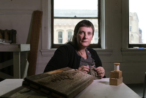 Artisit Corrie Peters was  Salt Springs Art winner recently.   Photo take of her in her studio with a spool of thread she used for her winning exhibition and pieces of her front door frame that was also part of her installation.   Oct 31, 2015 Ruth Bonneville / Winnipeg Free Press
