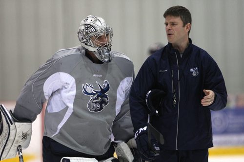 Manitoba Moose Connor Hellebuyck chats with head coach Keith McCambridge at practice Tuesday morning at MTS Iceplex -See story Nov 03, 2015   (JOE BRYKSA / WINNIPEG FREE PRESS)