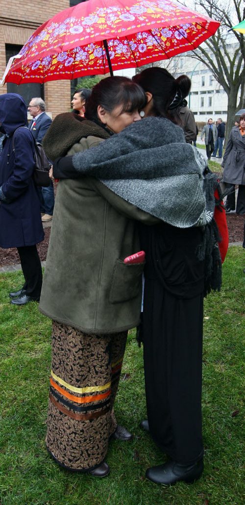 Residential school survivor Gerry Shingoose, left, gets a long hug from close friend Corra Lambert, right at the grand opening of the National Research Centre for Truth and Reconciliation, Chancellors Hall, 177 Dysart Road, University of Manitoba. Shingoose was five years old when a priest took her from her parents and to the Muscowequan Residential School in Saskatchewan. Shingoose was born in Manitoba, but was living in Hudson Bay, Sask, while her father worked in a bush camp.(from web) BORIS MINKEVICH / WINNIPEG FREE PRESS  NOV 3, 2015