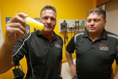 Dr Murray Hoy, left, with his brother Dr Gerald Hoy in their Opiate Addiction Treatment Centre at 968 Main St called Oats The two are seeing a dramatic increase in the street use of Fentanyl is a powerful synthetic opiate and are using Methadone to reduce withdrawal symptoms - Dr Murray Hoy holds bottle of Methadone-See Larry Kusch story  Nov 05, 2015   (JOE BRYKSA / WINNIPEG FREE PRESS)