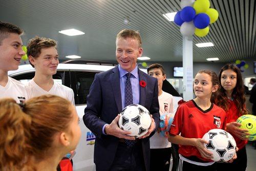 Biz: Dan Murray with Murray Chev Olds at Waverley Auto Mall chats with young soccer players after his dealership presented a cheque of $7,500 to members of the Winnipeg Youth Soccer Association on Thursday.   See Murray McNeil story.   Nov 5, 2015 Ruth Bonneville / Winnipeg Free Press