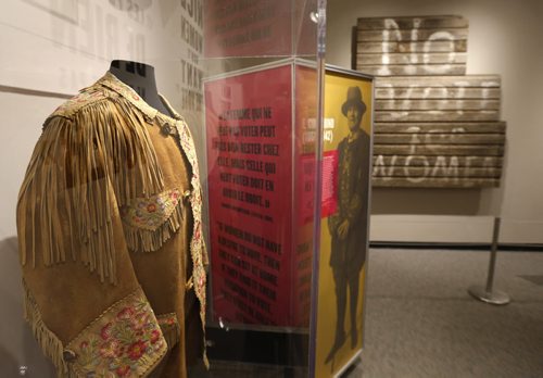 E. Cora Hind's famous moose hide jacket on display at the "Nice Women Don't Want the Vote" exhibit at the Manitoba Museum that opened Thursday. On the back wall is a section of a exterior house wall painted by a woman near Portage la Praire in 1915. She painted "Vote for Women" on the side of her house and when her husband arrived home he painted "No" in front of the words. Jen Zoratti story Wayne Glowacki / Winnipeg Free Press Nov. 5   2015