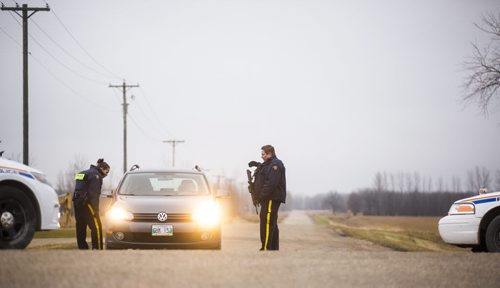 Police block Gosselin road at Highway 59 in their search for a potential suspect in St. Malo on Monday, Nov. 2, 2015.   (Mikaela MacKenzie/Winnipeg Free Press)