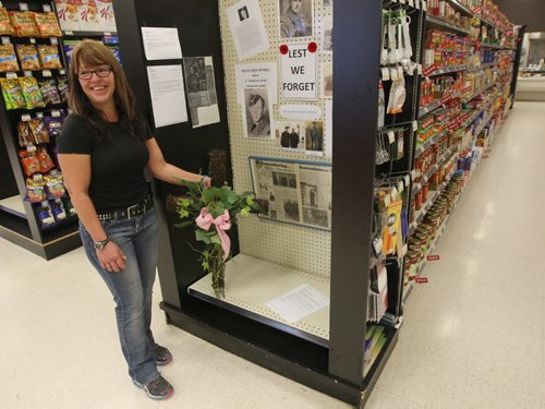 Store Manager, Ginette Maynard at BIGWAY Foods in St. Pierre Jolys, Manitoba- Store decided to not stock their store shelves with Christmas confectionary candies until after Remembrance Day in honour of those who fought in the wars.  Instead, they have a dozen photos placed on these empty shelves of war vets brought in by family and friends from the community.See story Nov 06, 2015   (JOE BRYKSA / WINNIPEG FREE PRESS)