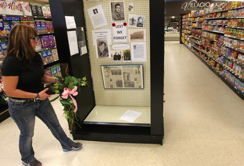 Store Manager, Ginette Maynard at BIGWAY Foods in St. Pierre Jolys, Manitoba- Store decided to not stock their store shelves with Christmas confectionary candies until after Remembrance Day in honour of those who fought in the wars.  Instead, they have a dozen photos placed on these empty shelves of war vets brought in by family and friends from the community.See story Nov 06, 2015   (JOE BRYKSA / WINNIPEG FREE PRESS)
