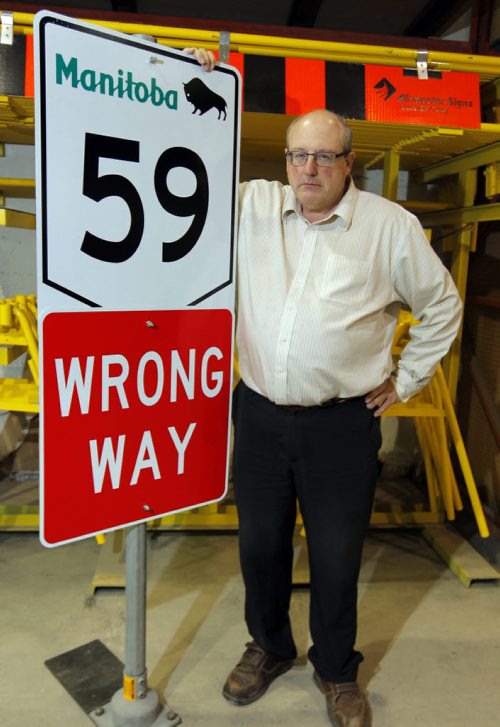 Keith MacCharles, co-owner of Airmaster, says his sign company has been effectively shut out of provincial tendering for highway signs for 20 years. Now speaking out. Poses with a sign. BORIS MINKEVICH / WINNIPEG FREE PRESS  NOV 6, 2015