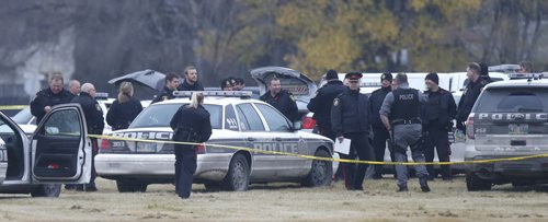 Winnipeg Police surround a vehicle in a field at the NW corner of  Grant Ave. and Kenaston Blvd. where the occupant was shot by police Friday afternoon.  Randy Turner story Wayne Glowacki / Winnipeg Free Press Nov. 6   2015