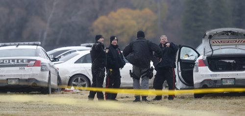 Winnipeg Police surround a vehicle in a field at the NW corner of  Grant Ave. and Kenaston Blvd. where the occupant was shot by police Friday afternoon.  Randy Turner story Wayne Glowacki / Winnipeg Free Press Nov. 6   2015