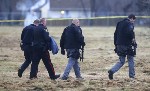 Winnipeg Police walk across the field at the NW corner of  Grant Ave. and Kenaston Blvd. where the occupant of a vehicle was shot by police Friday afternoon.  Randy Turner story Wayne Glowacki / Winnipeg Free Press Nov. 6   2015