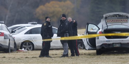 Winnipeg Police in a field at the NW corner of  Grant Ave. and Kenaston Blvd. where the occupant of a vehicle  was shot by police Friday afternoon.  Randy Turner story Wayne Glowacki / Winnipeg Free Press Nov. 6   2015