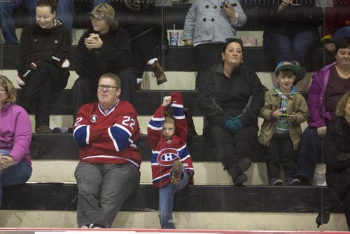 Chris Brown and his son, Casey, wear their jerseys and cheer as CN's hockey team challenges Canadiens alumni in a special game at the MTS Iceplex in Winnipeg on Saturday, Nov. 7, 2015.   (Mikaela MacKenzie/Winnipeg Free Press)