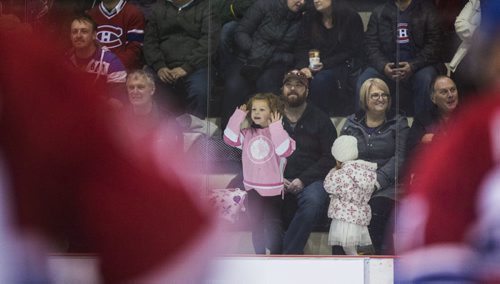 Maielle Arsenault, 4, watches as CN's hockey team challenges Canadiens alumni in a special game at the MTS Iceplex in Winnipeg on Saturday, Nov. 7, 2015.   (Mikaela MacKenzie/Winnipeg Free Press)