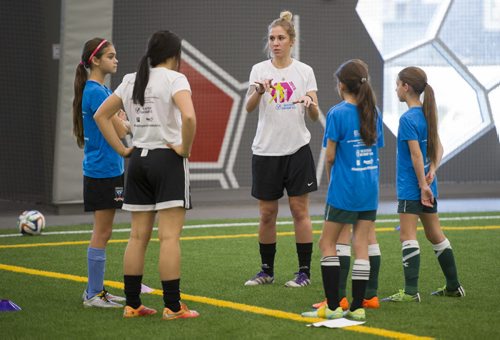 DAVID LIPNOWSKI / WINNIPEG FREE PRESS 151107  Dana Baker (centre) leads a group during the the second annual Desiree Scott Soccer Camp for Girls at Axworthy Health and RecPlex Saturday November 7, 2015.