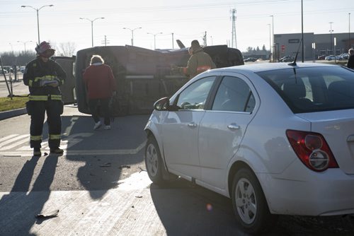 DAVID LIPNOWSKI / WINNIPEG FREE PRESS 151107  A two-vehicle collision that left one on its side is tying up traffic on Taylor Ave at the Walmart parking lot early Saturday November 7, 2015.