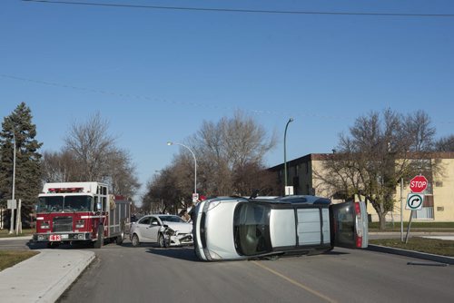 DAVID LIPNOWSKI / WINNIPEG FREE PRESS 151107  A two-vehicle collision that left one on its side is tying up traffic on Taylor Ave at the Walmart parking lot early Saturday November 7, 2015.