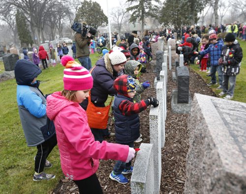Hailey, a grade 3 student from General Vanier School in the foreground was among the 200 students that took part in a Remembrance Day ceremony Tuesday at the Field of Honour section of the Elmwood Cemetery.   Alex Paul story Wayne Glowacki / Winnipeg Free Press Nov. 10  2015