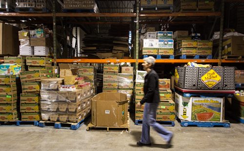 Volunteers work amongst the pallets of food in the warehouse at Winnipeg Harvest. For the Winnipeg Harvest 30th anniversary project.  151110 - Tuesday, November 10, 2015 -  MIKE DEAL / WINNIPEG FREE PRESS