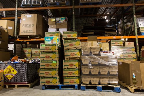 Volunteers work amongst the pallets of food in the warehouse at Winnipeg Harvest. For the Winnipeg Harvest 30th anniversary project.  151110 - Tuesday, November 10, 2015 -  MIKE DEAL / WINNIPEG FREE PRESS