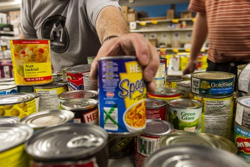 Volunteers work amongst the pallets of food in the warehouse at Winnipeg Harvest. For the Winnipeg Harvest 30th anniversary project.  151110 - Tuesday, November 10, 2015 -  MIKE DEAL / WINNIPEG FREE PRESS