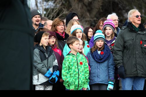 A large crowd surround the monument at Valour Road Memorial Park and sing Oh Canada during the Remembrance Day Service Wednesday.  Nov 11, 2015 Ruth Bonneville / Winnipeg Free Press