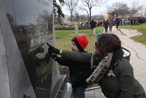 Four-year-old Maximus Murdock and his mom, Amanda, take a close look at the memorial stone honouring the soldiers who lost their lives in the 1st. and 2nd World Wars while attending the Remembrance Day service at Vimy Ridge Park Wednesday. 
 Nov 11, 2015 Ruth Bonneville / Winnipeg Free Press