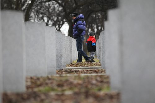 Jen Halley walks with her son Nixon - 3yrs (along with her family) around the hundreds of grave markers in the Field of Honour at Brookside Cememtary to pay special tribute to those who served in wars for our freedom on Remembrance Day Wednesday morning.   Nov 11, 2015 Ruth Bonneville / Winnipeg Free Press