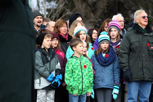 A large crowd surround the monument at Valour Road Commemorative Plaza and sing Oh Canada during the Remembrance Day Service Wednesday.  Nov 11, 2015 Ruth Bonneville / Winnipeg Free Press