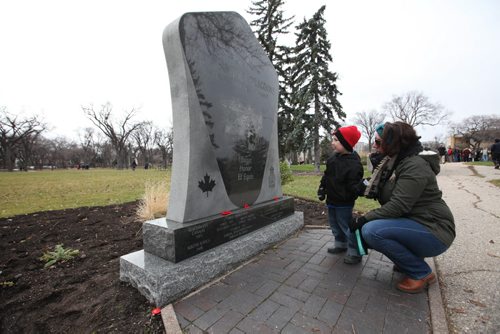 Four-year-old Maximus Murdock and his mom, Amanda, take a close look at the memorial stone honouring the soldiers who lost their lives in the 1st. and 2nd World Wars while attending the Remembrance Day service Wednesday at Vimy Ridge Park.   Nov 11, 2015 Ruth Bonneville / Winnipeg Free Press