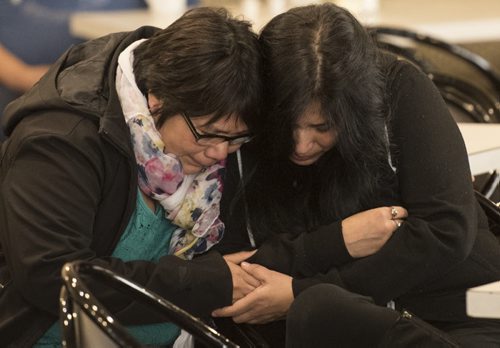 DAVID LIPNOWSKI / WINNIPEG FREE PRESS 151111  Krystal Andrews' mother Beverley Andrews (left) is comforted by her first cousin Geraldine during a memorial Wednesday night at the Quest Inn.