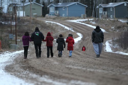 Photos for  Mary Agnes feature piece on CFS, Nelson House First Nation. Photo of mother with her children as they walk along the road in their community.  This mother cannot be identified due to her involvement with CFS.  She has received help from the Wellness Centre and now is back in her home with her children. This mother and her children cannot be identified due to her involvement with CFS.  See story.     Nov 04, 2015 Ruth Bonneville / Winnipeg Free Press